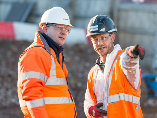 two men talking on site